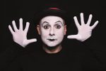 White face mime acting out moves