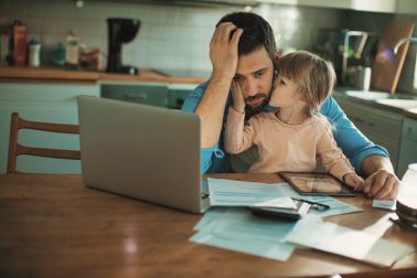 Father working from home with young daughter